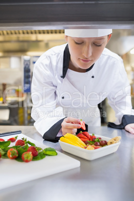 Chef garnishing fruit basket