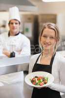Waitress holding a salad