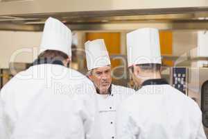 Angry head chef scolding employees