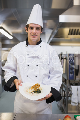 Smiling chef presenting his plate