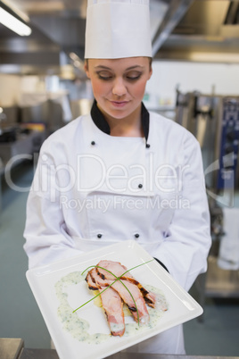 Smiling chef looking down at her plate
