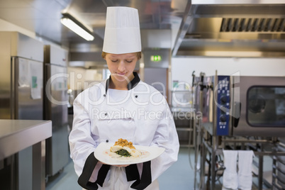 Happy chef showing her plate