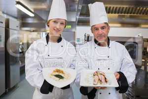 Two Chef's presenting their dishes