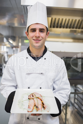 Smiling cook holding his meal