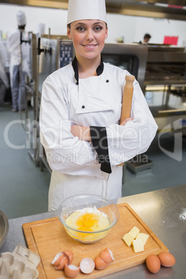 Smiling pastry chef with rolling pin