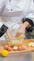 Chef mixing dough with hands