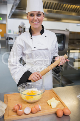 Woman holding a rolling pin while making dough