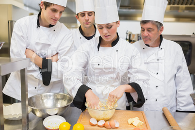 Culinary students learning how to mix dough