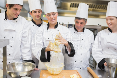 Class watching pastry teacher forming the dough