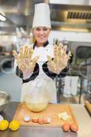Baker showing her hands with dough