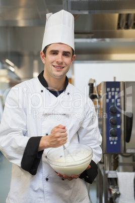 Cheerful man mixing batter