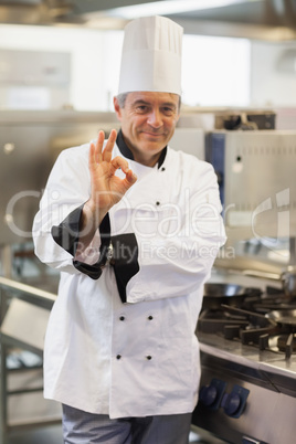 Chef giving ok symbol by the stove