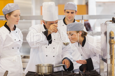 Student tasting the teacher's soup