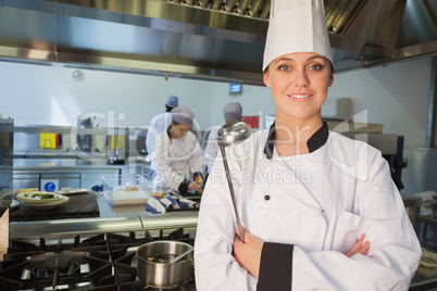 Smiling chef holding ladle
