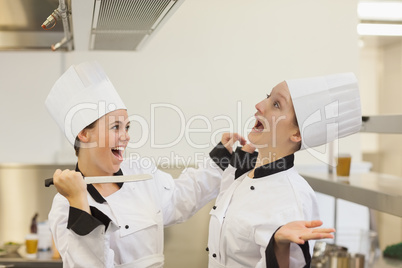 Two Chef's joking in the kitchen