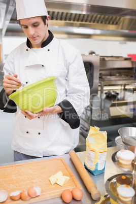 Chef mixing dough with a whisk