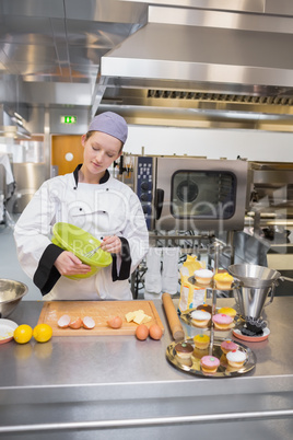 Female baker mixing dough