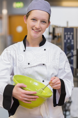 Female baker mixing in the kitchen