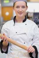 Smiling chef holding rolling pin