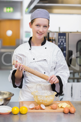 Woman holding a rolling pin and preparing the dough
