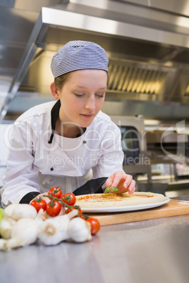 Female cook preparing pizza