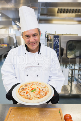 Chef holding pizza