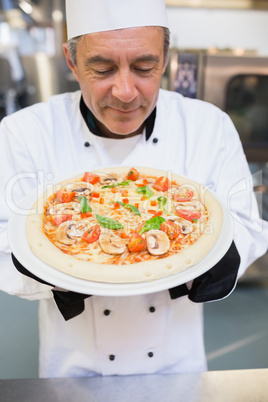 Chef smelling pizza