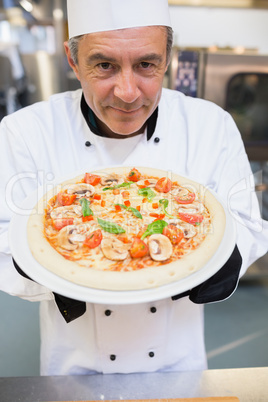 Man presenting a pizza
