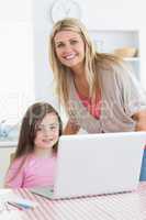 Mother and child smiling with a laptop