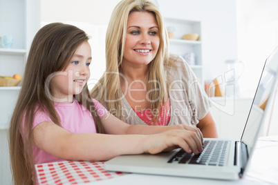 Mother and daughter sitting at the kitchen