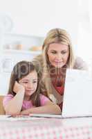 Mother and child looking at laptop