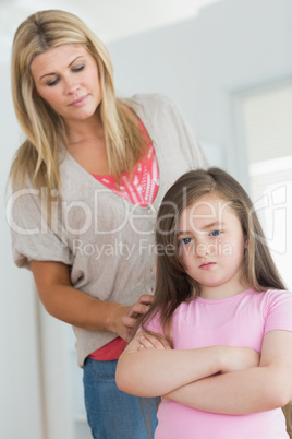 Mother trying to comfort angry daughter