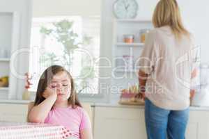 Child falling asleep at kitchen table