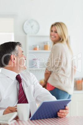 Couple smiling at each other at the kitchen before work