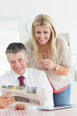 Couple reading a newspaper together