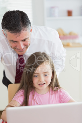 Father and child looking at a laptop