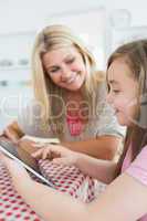 Woman and daughter holding a tablet pc