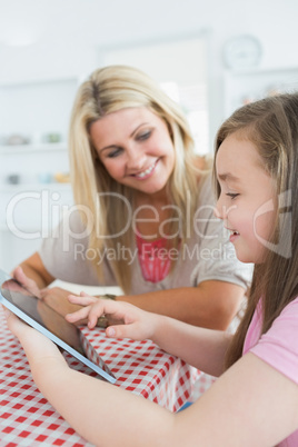 Mother and little girl using a tablet pc