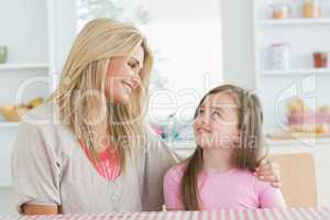 Mother and child looking at each other in kitchen