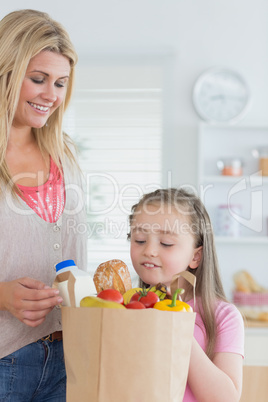 Child looking into grocery bag