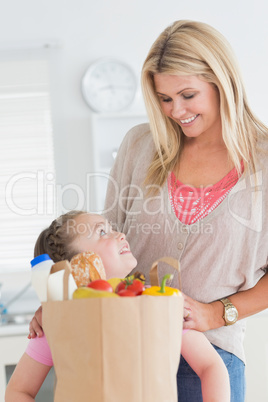 Little girl looking at her mother after grocery shopping