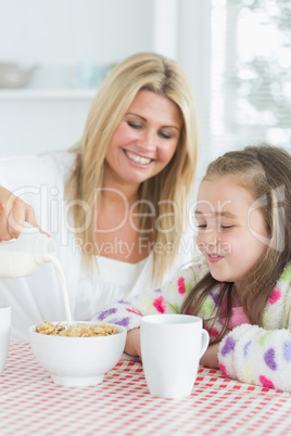 Mother and daughter having cereal