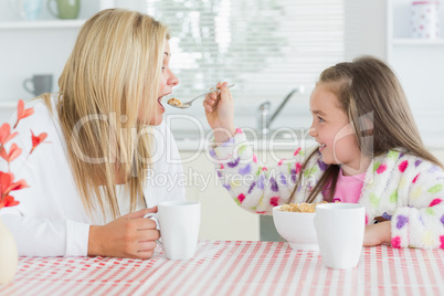 Girl feeding her mother