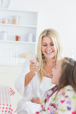 Mother feeding her child cereal