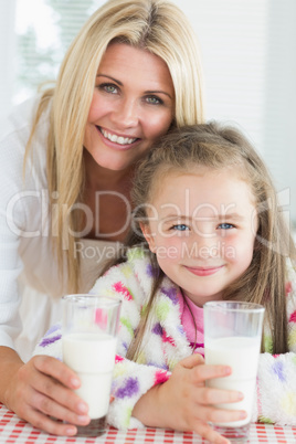 Mother and girl drinking milk