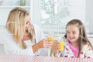 Mother and child drinking juice