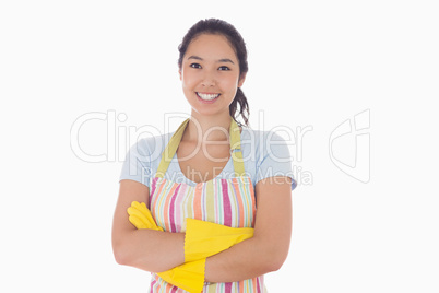 Smiling woman wearing apron and rubber gloves