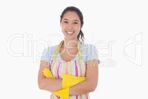 Smiling woman wearing apron and rubber gloves