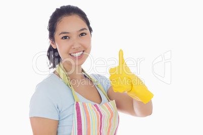 Woman giving thumbs up in yellow rubber gloves