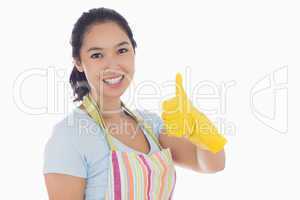 Woman giving thumbs up in yellow rubber gloves